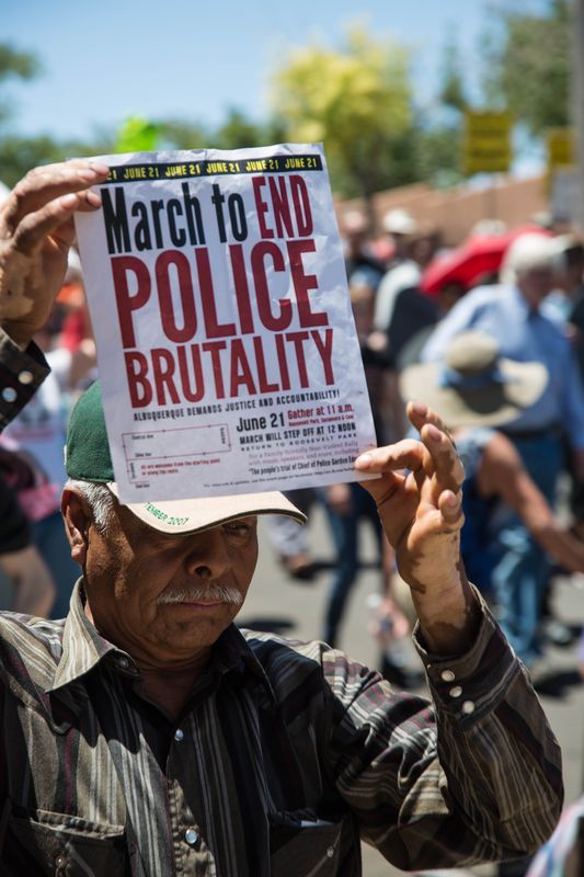 A marcher holds the flyer on Saturday, June 21, "March to End Police Brutality."